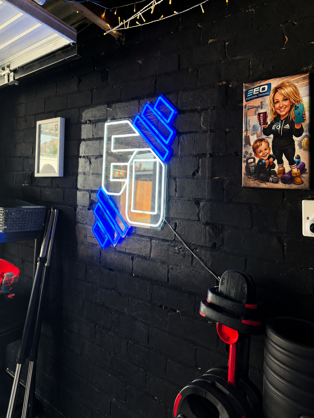 EO Training neon sign glowing on the black brick wall of the Gosport studio